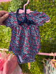 Floral skirted onesie w/bow nb
